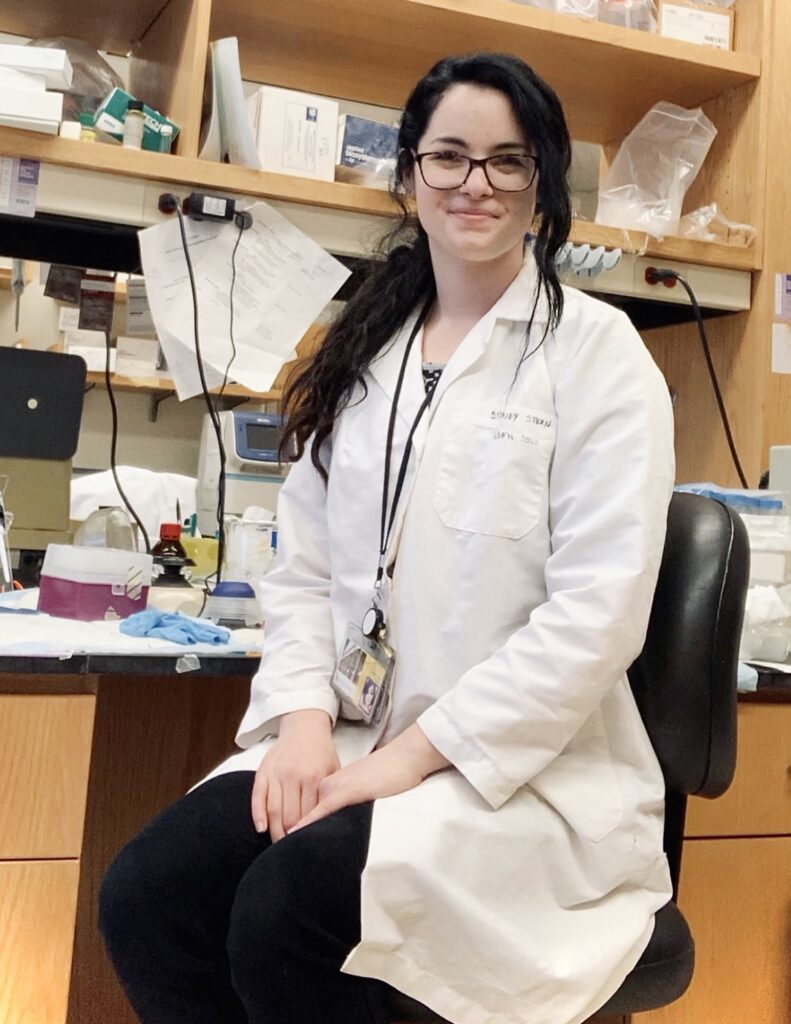 Dr Sydney Stern sitting at her bench at University of Maryland Baltimore in 2021. Photo provided by: Sydney Stern