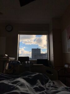 Vancouver General Hospital room with a window view of blue skies and clouds from a patient lying in bed’s perspective.