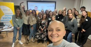 A group of training participants displayed in a selfie by a cancer patient